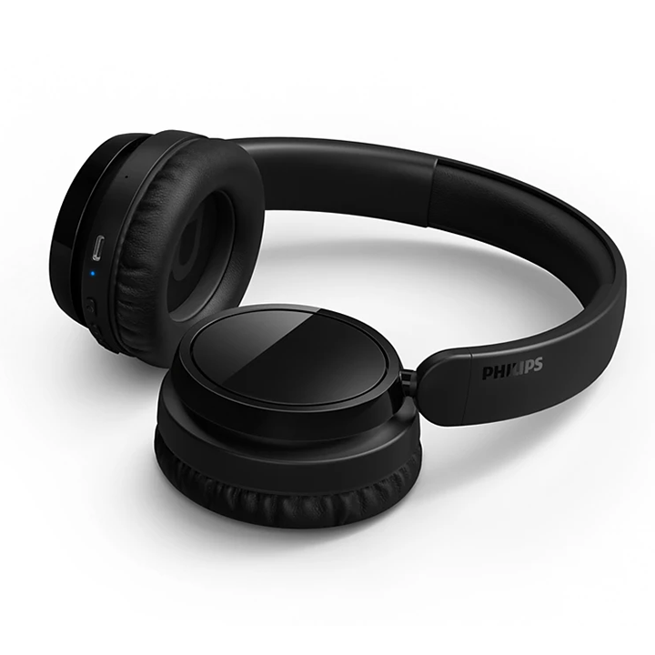 Philips TAH5209BK wireless headphones resting with flat swivel earcups and USB-C port